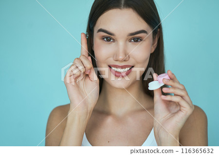 Eye Care, Vision Correction. Woman Holding Contact Lens Case with Instructional Gesture Eye Care, Vision Correction. Woman Holding Contact Lens Case with Instructional Gesture 116365632