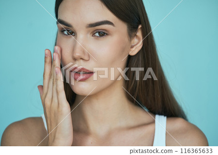 Natural Beauty. Woman with Glowing Skin on Blue Background 116365633