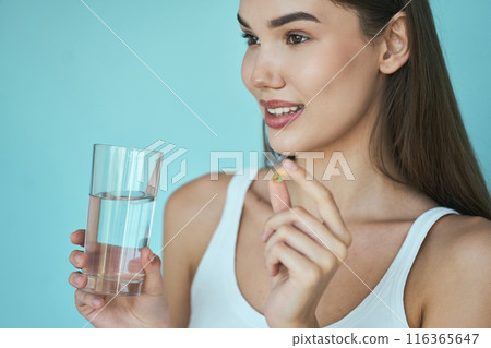 Diet. Woman Holding Water Glass And Taking Supplement Diet. Woman Holding Water Glass And Taking Supplement 116365647