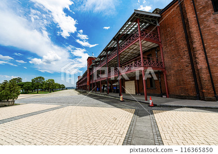 Red brick warehouse shining against the blue sky Red brick warehouse shining against the blue sky 116365850
