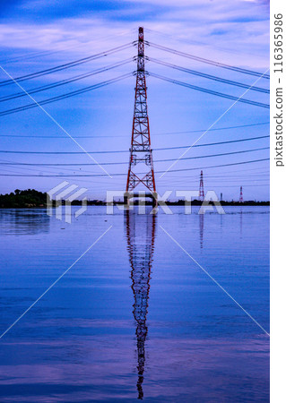 Steel tower reflected on the surface of the water Steel tower reflected on the surface of the water 116365986