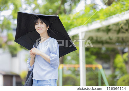 A woman holding a parasol A woman holding a parasol 116366124