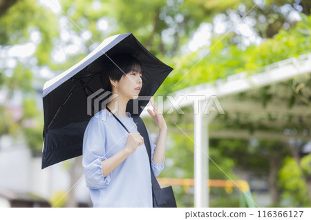 A woman holding a parasol A woman holding a parasol 116366127