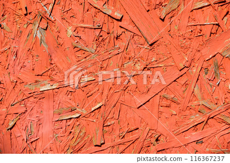 Priented strand board OSB painted in red. Sterling board background 116367237