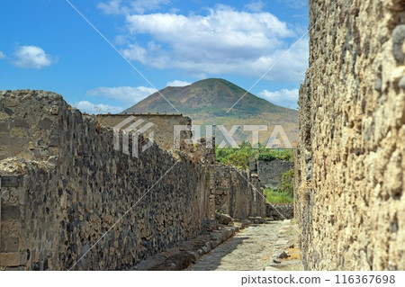 View of the historic ruined city of Pompeii in Italy with the volcano Vesuv View of the historic ruined city of Pompeii in Italy with the volcano Vesuv 116367698
