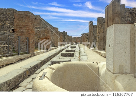 View of the historic ruined city of Pompeii in Italy with the volcano Vesuv View of the historic ruined city of Pompeii in Italy with the volcano Vesuv 116367707