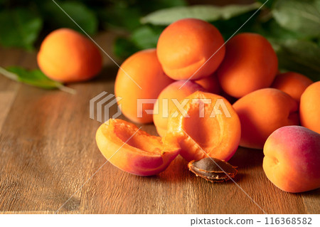 Fresh juicy apricots on a wooden table. Fresh juicy apricots on a wooden table. 116368582