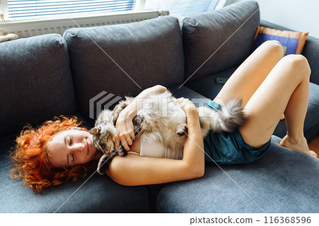 portrait red-haired attractive young woman with fluffy big cat portrait red-haired attractive young woman with fluffy big cat 116368596