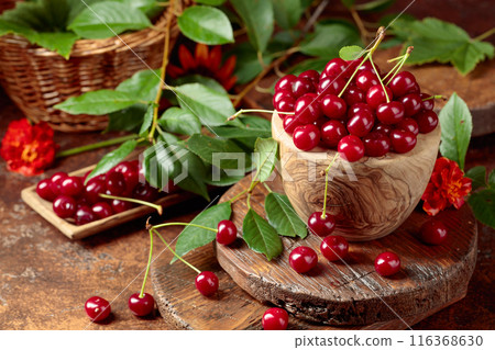 Ripe red cherries in a wooden dish. Ripe red cherries in a wooden dish. 116368630