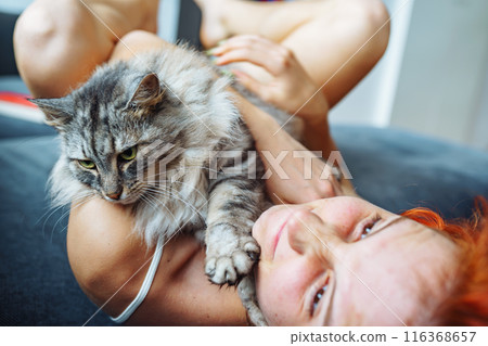 portrait red-haired attractive young woman with fluffy big cat 116368657