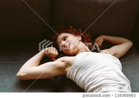 portrait muscular attractive young woman showing off muscles on arms 116368663