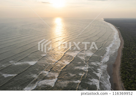 Reflection of sunset sun on ocean 116369952
