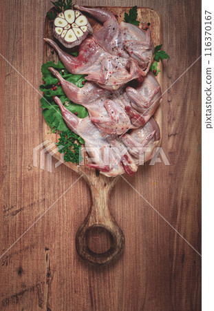 Raw quail meat, on a cutting board, with spices and herbs, top view, Raw quail meat, on a cutting board, with spices and herbs, top view, 116370167