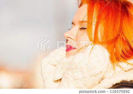Beauty face redhaired woman in warm clothing outdoor 116370892