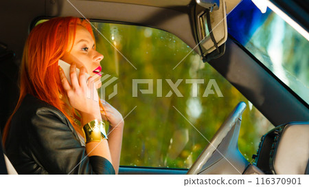 girl talking on mobile phone while driving the car. girl talking on mobile phone while driving the car. 116370901