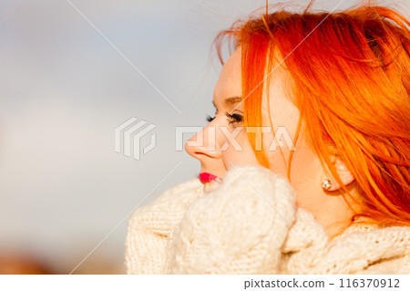Beauty face redhaired woman in warm clothing outdoor 116370912
