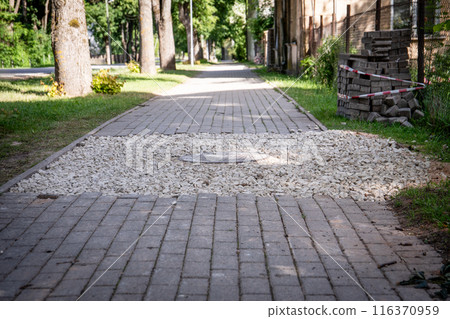 Paving bricks piled by sidewalk, construction work 116370959