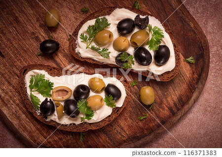Breakfast, sandwiches, with cream cheese, olives, top view, 116371383