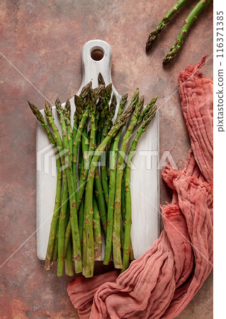 Bouquet of fresh asparagus, on an abstract background, top view, rustic, no people 116371385