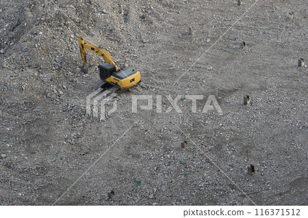 top view old black and yellow excavator is shoveling stones. construction area background, technology, onstruction, object, copy space top view old black and yellow excavator is shoveling stones. construction area background, technology, onstruction, object, copy space 116371512