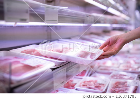 Woman's hand holding a package of pork 116371795