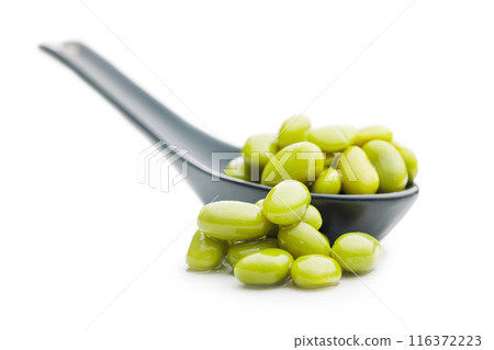 Edamame soy beans in ceramic spoon isolated on white background. Edamame soy beans in ceramic spoon isolated on white background. 116372223