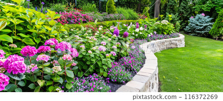 Terraced home garden with stone retaining walls, design of luxury house backyard or landscaped yard. Concept of landscaping, flower, summer, nature 116372269