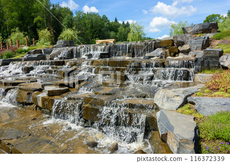 Water flowing over rocks in a cascading waterfall. Water flowing over rocks in a cascading waterfall. 116372339