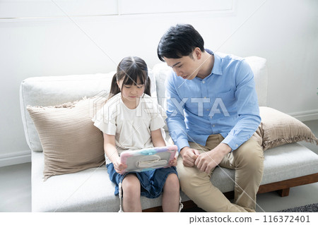 Father and daughter looking at tablet Father and daughter looking at tablet 116372401