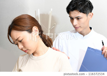 Young Asian woman receiving a checkup from a chiropractor 116372534