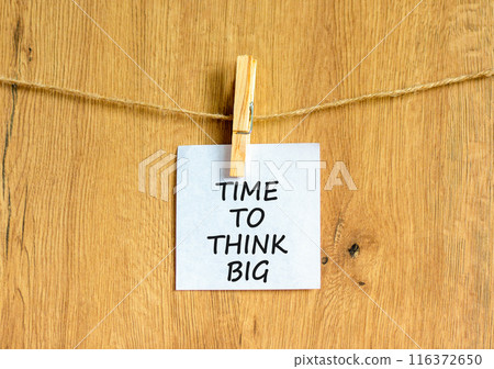 Time to think big symbol. Concept words Time to think big on beautiful white paper on clothespin. Beautiful wooden background. Business and time to think big concept. Copy space. 116372650