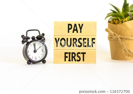 Pay yourself first symbol. Concept words Pay yourself first on beautiful wooden blocks. Beautiful white table white background. Black alarm clock. Business and pay yourself first concept. Copy space. Pay yourself first symbol. Concept words Pay yourself first on beautiful wooden blocks. Beautiful white table white background. Black alarm clock. Business and pay yourself first concept. Copy space. 116372700
