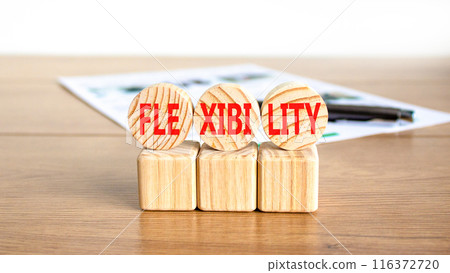 Flexibility symbol. Concept word Flexibility on beautiful wooden circles. Beautiful wooden table white background. Black pen. White document. Business flexibility concept. Copy space. 116372720