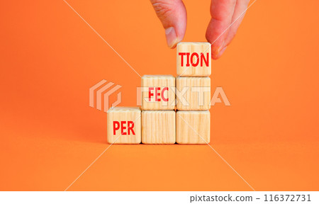 Perfection symbol. Concept word Perfection on beautiful wooden blocks. Businessman hand. Beautiful orange background. Business perfection concept. Copy space. 116372731