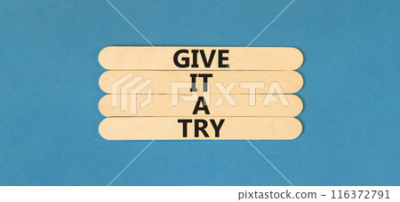 Give it a try symbol. Concept word Give it a try on beautiful wooden stick. Beautiful blue table blue background. Business give it a try concept. Copy space. 116372791