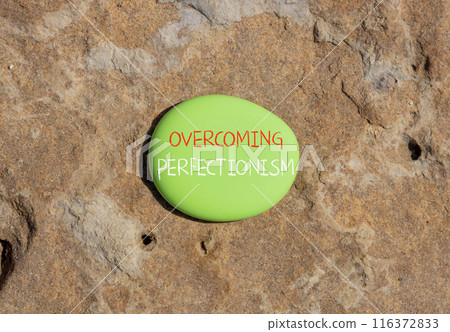Overcoming perfectionism symbol. Concept words Overcoming perfectionism on beautiful green stone. Beautiful red stone background. Business Overcoming perfectionism concept. Copy space. 116372833