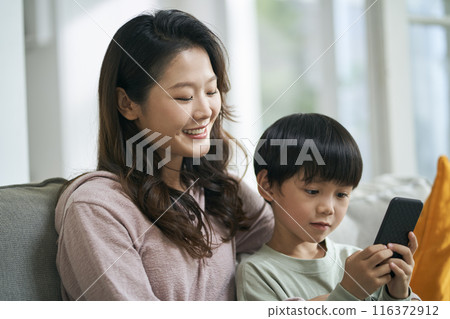 young asian mother keeping company with son young asian mother keeping company with son 116372912