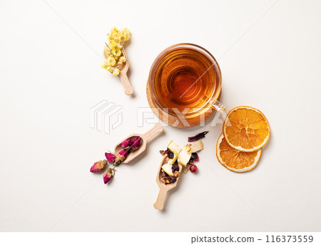 A cup of herbal tea with dried flowers, fruits and berries. The concept of healthy eating. Top view 116373559