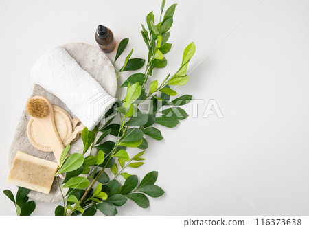 Flat lay of facial and body care cosmetics with soap, brush, sponge, creme and towel   116373638