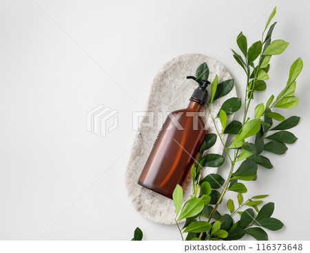 Concept flat lay of brown glass bottle for body lotion on marble board on white background Concept flat lay of brown glass bottle for body lotion on marble board on white background 116373648