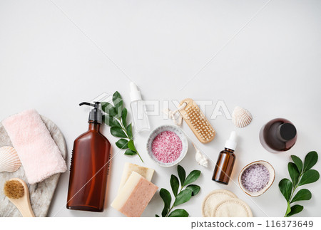 Concept flat lay of facial and body care cosmetics with sea salt, soap, sponge, brush, lotion Concept flat lay of facial and body care cosmetics with sea salt, soap, sponge, brush, lotion 116373649