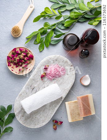 Creative flat lay  of facial and body care cosmetics with sea salt, soap, cream and brush 116373692