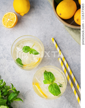 Lemonade soda drink with fresh lemons. Refreshing cocktails with lemon, mint and ice  116373983