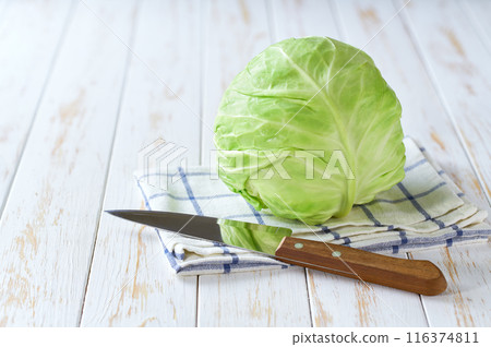 fresh cabbage on a light wooden table, selective focus. 116374811