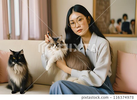 A woman who plays with a cat 116374978