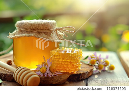 Honey in a jar and honeycombs on a wooden background Honey in a jar and honeycombs on a wooden background 116375503
