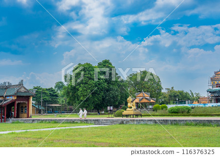 A woman dressed in formal attire walks in front of a golden dragon at the Hue Imperial Palace, a World Heritage site that preserves the splendor of Vietnam's last dynasty, on National Day. A woman dressed in formal attire walks in front of a golden dragon at the Hue Imperial Palace, a World Heritage site that preserves the splendor of Vietnam's last dynasty, on National Day. 116376325