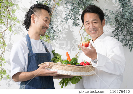 A chef checking the vegetables delivered from the farm. A chef who has a direct contract with the farmer. A chef checking the vegetables delivered from the farm. A chef who has a direct contract with the farmer. 116376450