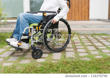 A wheelchair resting on a tiled road 116378790