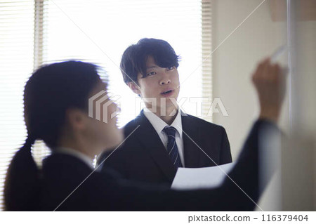 A male employee and a female colleague explaining the proposal at a meeting. A male employee and a female colleague explaining the proposal at a meeting. 116379404